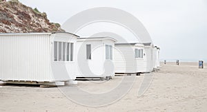 The beautiful white beach cabins at Blokhus Beach in Denmark