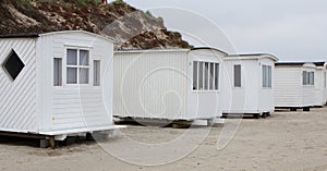 The beautiful white beach cabins at Blokhus Beach in Denmark