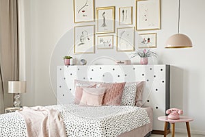 Beautiful white bedroom interior with feminine decor, polka dot