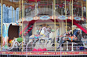 Beautiful white and black horses carousel in a holiday park. Merry-go-round carrossel with horses