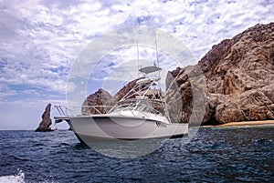 Beautiful white boat by the rocks