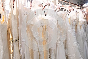 Beautiful, White bridal dress texture on background. Wedding dresses hanging on a hanger interior of bridal salon.