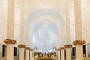 Beautiful White Buddha statue in a white hall at Wat Huay Pla Kung, the beautiful and famous Thai-Chinese temple in Chiang Rai