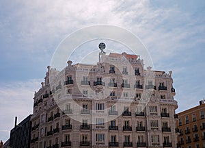 Beautiful white building against blue sky at Calle Gran Via, Madrid, Spain photo