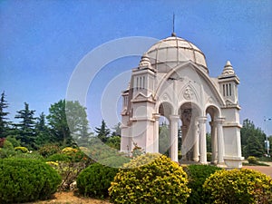 Beautiful white building in a park with a blue sky in the background