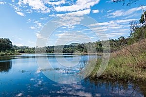 Beautiful white clouds against the blue sky is mirrored in the water.