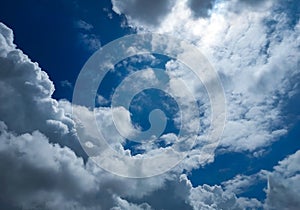 Beautiful white clouds in blue sky background, nature photography, natural wallpaper, sun hiding behind cumulus cloud