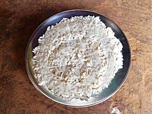 Beautiful white color flattened rice preparing for breakfast in silver plate photo