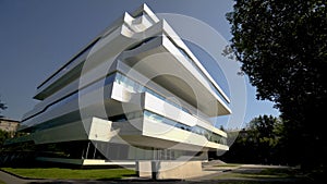 Beautiful white facade of futuristic office building. Action. Facade of business center in avant-garde style on