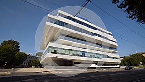 Beautiful white facade of futuristic office building. Action. Facade of business center in avant-garde style on