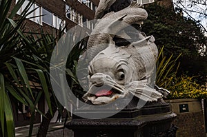 Beautiful white fish enveloping street lamp in London, a charac