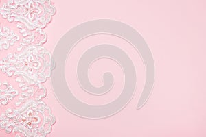 Beautiful white floral lace on a pink background