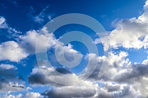 Beautiful white fluffy cloud formations in a deep blue summe sky