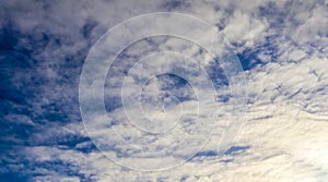 Beautiful white fluffy cloud formations in a deep blue summe sky