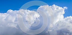 Beautiful white fluffy clouds in a deep blue summer sky