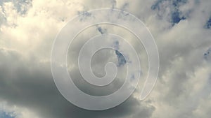 Beautiful white fluffy clouds slowly float against the blue sky on a warm sunny summer day. Timelapse video of cloud