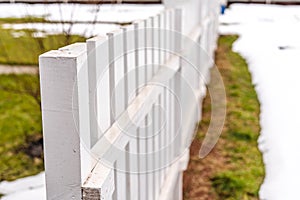 Beautiful white garden fence made of wood close up