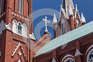 Beautiful white iron cross on a Gothic Revival church