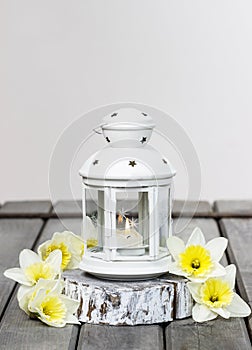 Beautiful white lantern with burning candle inside