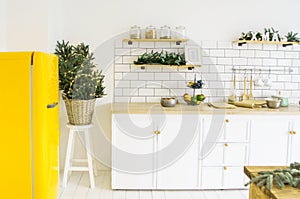 beautiful white cosy modern kitchen interior,kitchenware, home style, with bright yellow fridge , christmas decorations