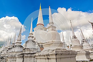 Beautiful white pagodas with blue sky and white clouds background, Wat Phra Mahathat Woramahawihan.