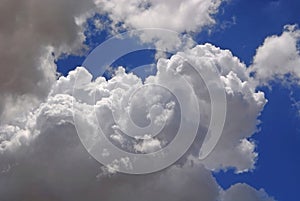 white puffy clouds in blue sky