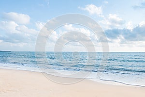 Beautiful white sand beach and ocean waves with clear blue sky photo
