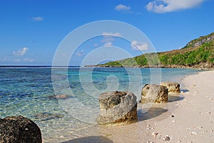Beautiful white sand beach with rocks on the shore