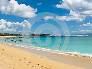 Beautiful white sand beach surrounded by tropical palm trees on the island of Bali in Nusa Dua area. photo