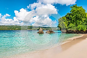 Beautiful white sand beach and turquoise water on tropical Island of Cayo Levantado, Samana Bay, Dominican Republic.