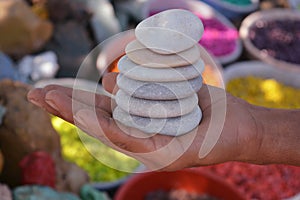 Beautiful white stones pebbels in hand background