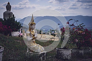 beautiful white stucco Buddha statue enshrined on the hillside It is a place of meditation called Wat Sutesuan.