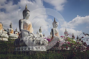 beautiful white stucco Buddha statue enshrined on the hillside It is a place of meditation called Wat Sutesuan.