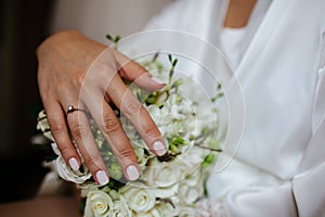 Beautiful white wedding bouquet with bride sitting in the background - shallow dof