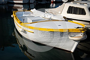 A beautiful white, yellow fishing boat on a sunny day