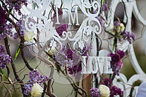 Beautiful whitel floral sign decoration at wedding aisle