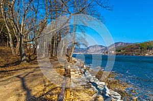 Beautiful wide angle view of seaside pedestrian walk at Nami Island, South Korea with awesome and calm blue sky and blue water few