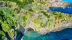 Beautiful wild coast scenery view with Bridal Veil Falls (Veu da noiva) at Ponta do Poiso in Madeira Island. Aerial view photo