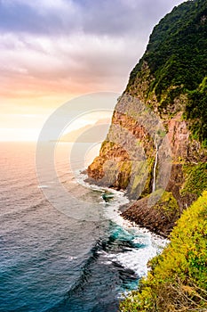 Beautiful wild coast scenery view with Bridal Veil Falls (Veu da noiva) at Ponta do Poiso in Madeira Island. Near Porto Moniz,