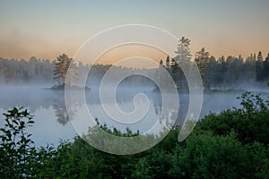 Beautiful wild lake in the morning mist