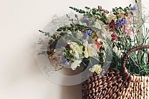 Beautiful wildflowers in wicker bag at rustic window. colorful f