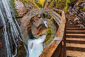 Beautiful Wimbachklamm gorge with wooden path in autumn colors, Ramsau bei Berchtesgaden