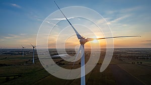 Beautiful wind turbine in the countryside in the time of sunset background. Wind Turbines Windmill Power Farm