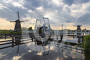 Beautiful windmill and drawbridge on a canal in Kinderdijk in Holland