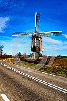 Beautiful windmill located next to a disappearing road