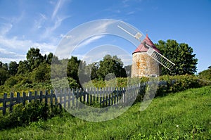 Beautiful Windmill with Old Wooden Fence in L\'Isle-aux-Coudres Quebec