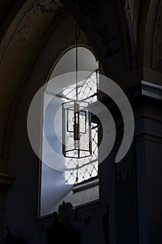 Beautiful window and a lamp in the german catholic church. Light and shadow, details. Pilgrimage Church Wallfahrtskirche