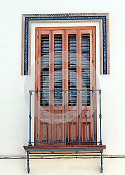 Beautiful window with shutters and small balcony in Dos Hermanos