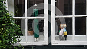 Beautiful window with statues in the street of old town, Lubeck, Germany