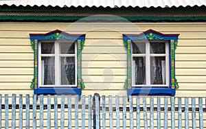 Beautiful windows with carved platbands on the facade